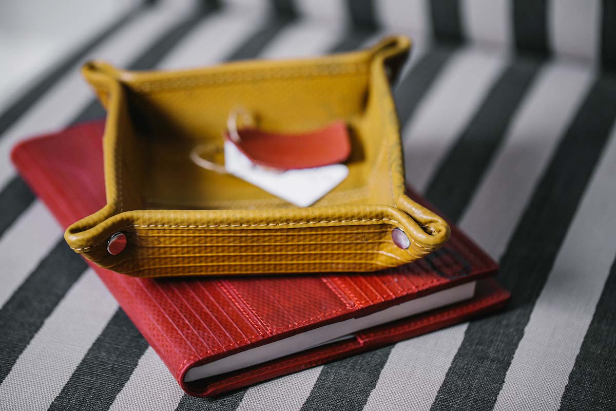 Mustard yellow desk tidy made from genuine decommissioned red British fire-hose by Elvis & Kresse for AUTHOR Interiors' collection of luxury desk trays
