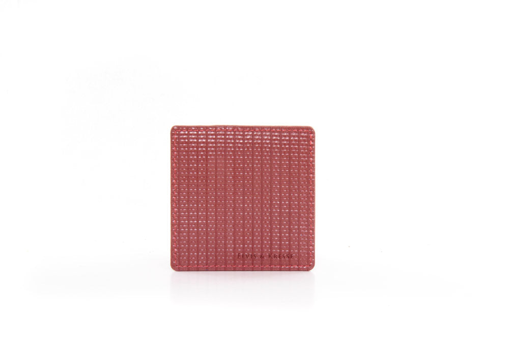 Reclaimed firehose coaster in red made in the UK by Elvis & Kresse for AUTHOR Interiors' collection of ethical and sustainable homeware